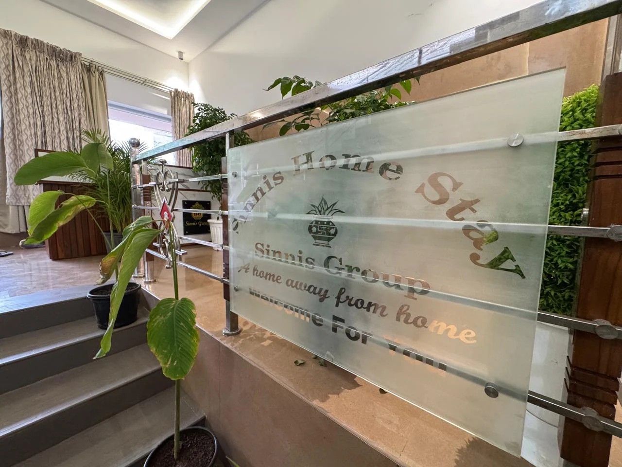 Etched glass welcome sign at Sinnis Home Stay reading “A home away from home”